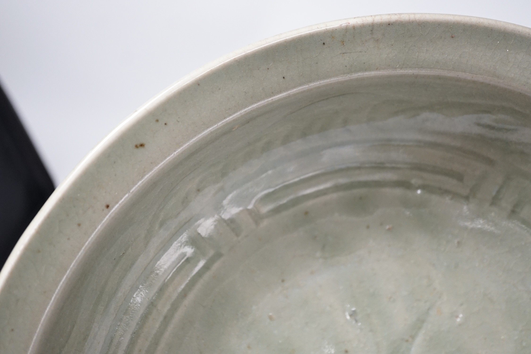 A Chinese Celadon charger. 34cm diameter